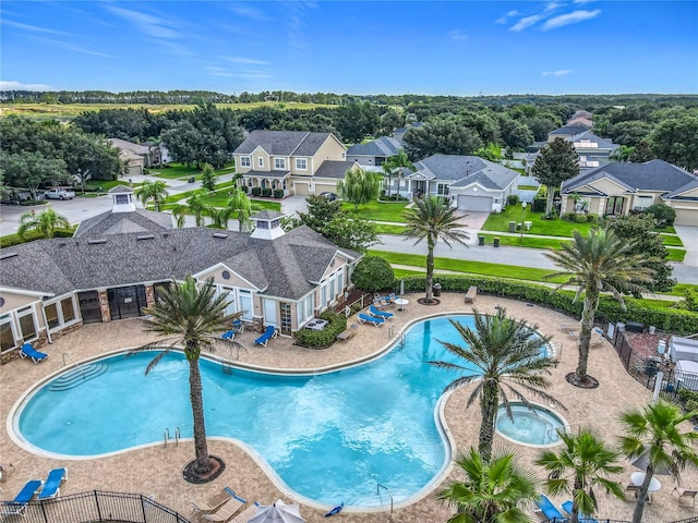 3731 Peaceful Valley Dr, Clermont, FL 34711 - community pool featuring a hot tub, a residential view, and a patio area