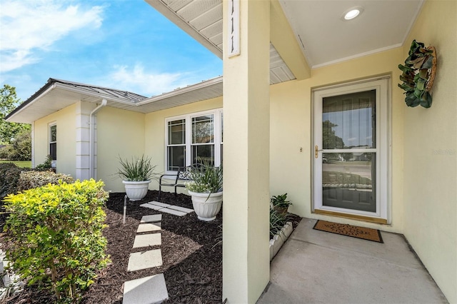 entrance to property featuring stucco siding
