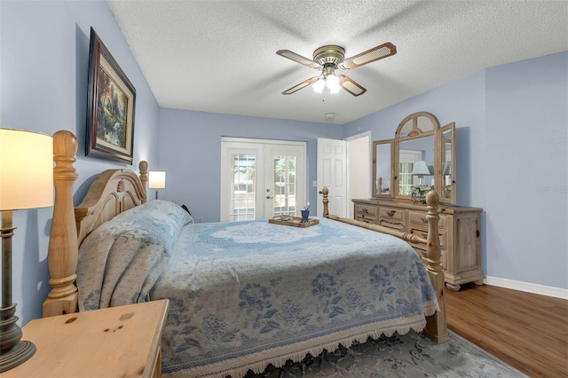 bedroom with wood finished floors, access to outside, baseboards, french doors, and a textured ceiling