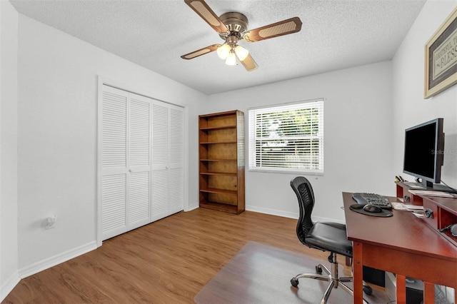home office featuring wood finished floors, a ceiling fan, a textured ceiling, and baseboards