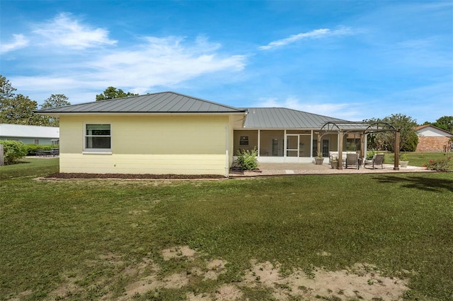 back of house with a yard, metal roof, a pergola, and a patio