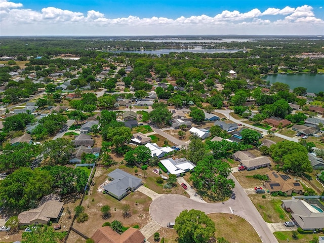 aerial overview of property's location with a large body of water and nearby suburban area