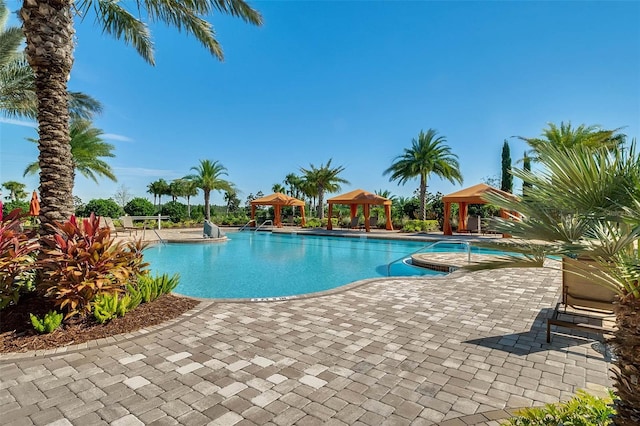 1027 Timbervale Trl, Clermont, FL 34715 - community pool featuring a gazebo and a patio area