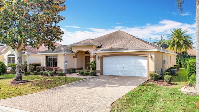 2202 Kershaw Rd, The Villages, FL 32162 - view of front of home featuring stucco siding, a garage, decorative driveway, a front lawn, and a shingled roof