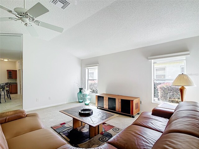 2202 Kershaw Rd, The Villages, FL 32162 - living room with carpet floors, a ceiling fan, a textured ceiling, and baseboards