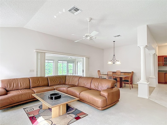 2202 Kershaw Rd, The Villages, FL 32162 - living area featuring ornate columns, lofted ceiling, light colored carpet, a ceiling fan, and a textured ceiling