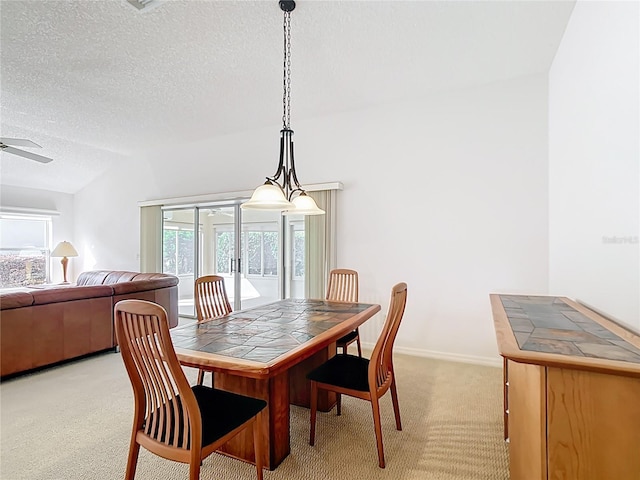 2202 Kershaw Rd, The Villages, FL 32162 - dining room featuring light carpet, a textured ceiling, a ceiling fan, baseboards, and lofted ceiling
