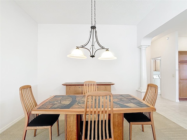 2202 Kershaw Rd, The Villages, FL 32162 - dining room featuring ornate columns, light carpet, washer / clothes dryer, and baseboards
