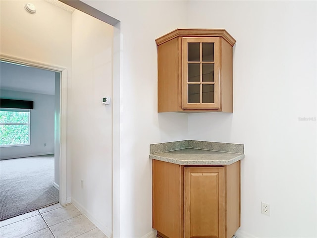 2202 Kershaw Rd, The Villages, FL 32162 - hallway featuring baseboards, light colored carpet, and light tile patterned floors