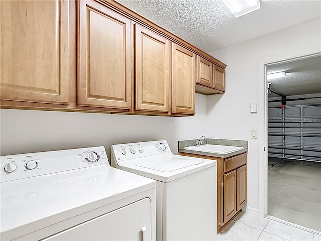 2202 Kershaw Rd, The Villages, FL 32162 - laundry area with washer and dryer, cabinet space, a textured ceiling, and light tile patterned floors