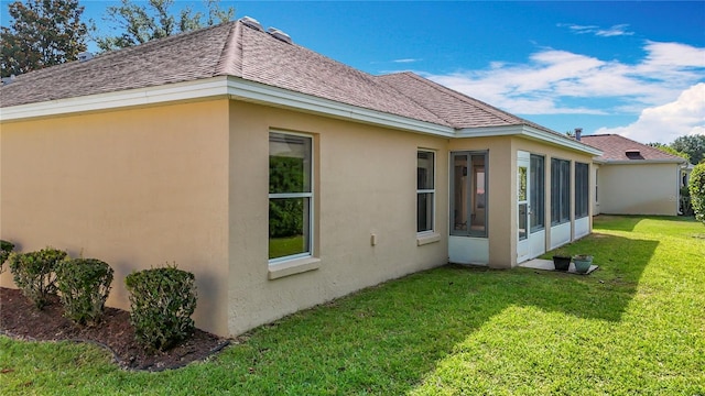 2202 Kershaw Rd, The Villages, FL 32162 - back of house with stucco siding, a yard, a shingled roof, and a sunroom