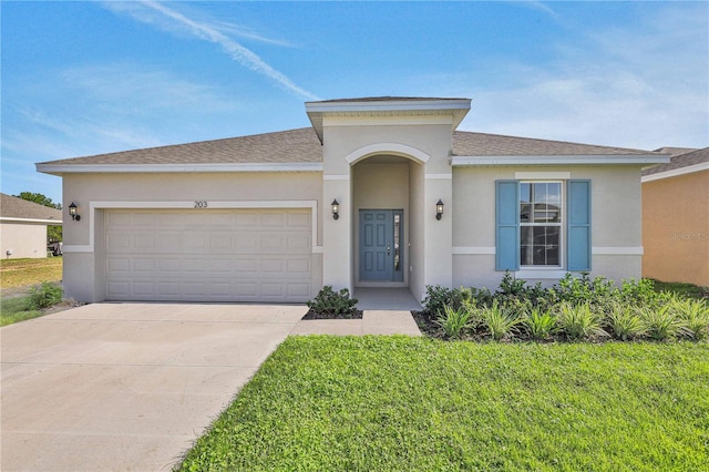 view of front facade featuring an attached garage, concrete driveway, roof with shingles, and stucco siding