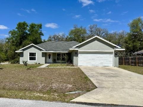 single story home with an attached garage, driveway, and stucco siding