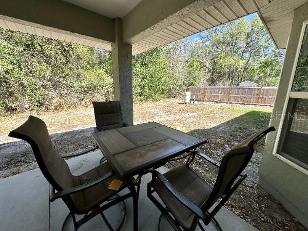 view of patio featuring fence and outdoor dining area