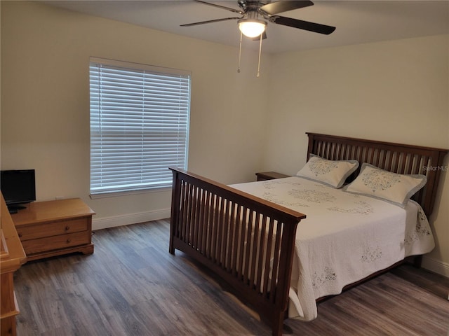 bedroom with wood finished floors, baseboards, and ceiling fan