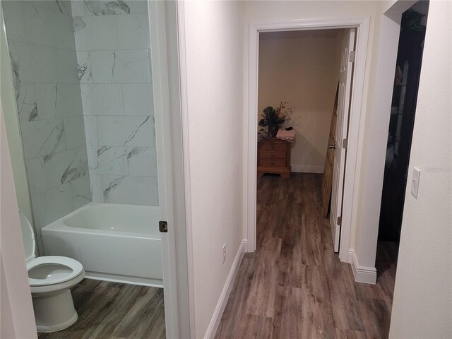 hall with wood finished floors and baseboards