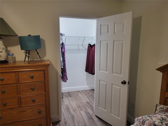 bedroom with wood finished floors and baseboards