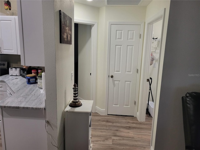 corridor featuring light wood finished floors