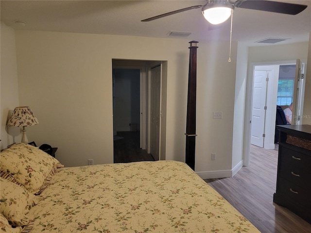 bedroom with wood finished floors, baseboards, and ceiling fan