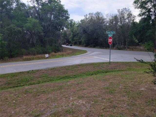 view of asphalt road with traffic signs