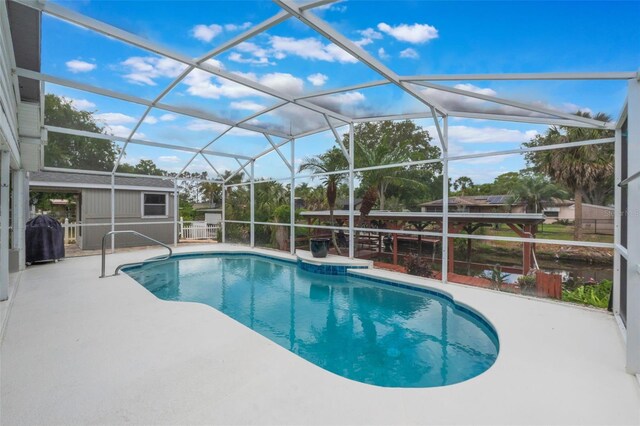12401 Blue Heron Way, Leesburg, FL 34788 - swimming pool with a patio area, grilling area, and glass enclosure