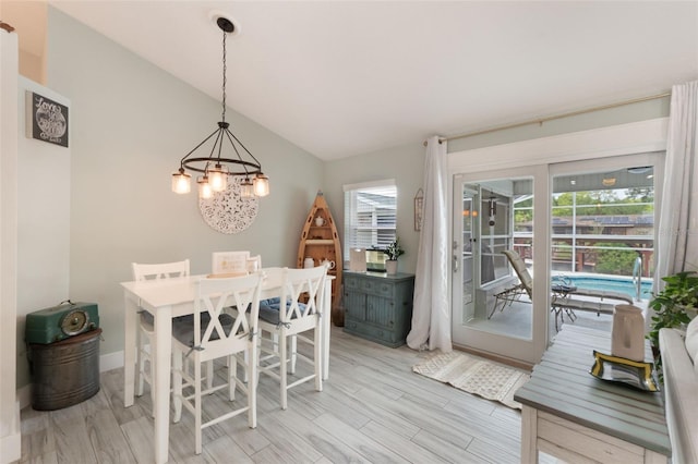 12401 Blue Heron Way, Leesburg, FL 34788 - dining area featuring a chandelier, healthy amount of natural light, light wood-style floors, and lofted ceiling