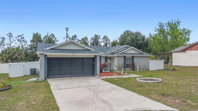 2304 Clementine Trl, Clermont, FL 34714 - ranch-style home with an attached garage, a gate, concrete driveway, brick siding, and roof with shingles