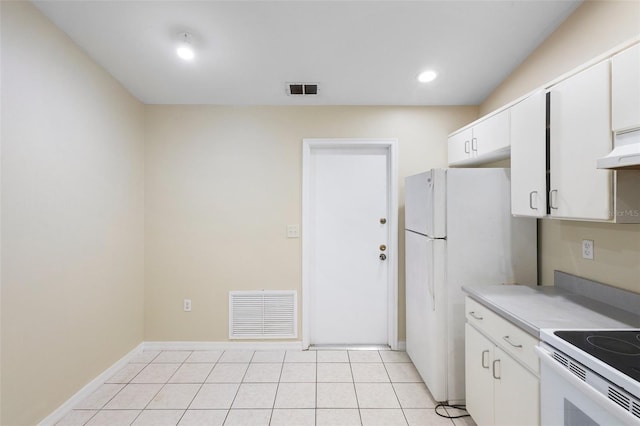 2304 Clementine Trl, Clermont, FL 34714 - kitchen with white appliances, white cabinets, light countertops, light tile patterned floors, and recessed lighting