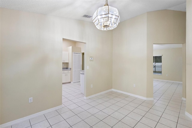 2304 Clementine Trl, Clermont, FL 34714 - unfurnished room featuring light tile patterned floors, a chandelier, a textured ceiling, and lofted ceiling