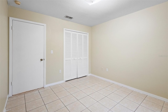 2304 Clementine Trl, Clermont, FL 34714 - unfurnished bedroom with a closet and light tile patterned floors