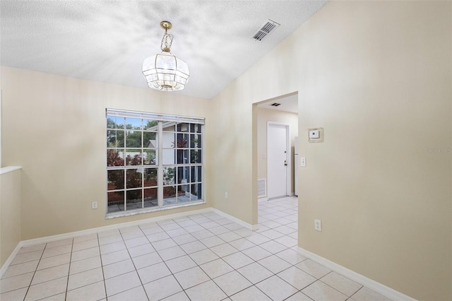 2304 Clementine Trl, Clermont, FL 34714 - spare room featuring a textured ceiling, a chandelier, light tile patterned floors, and lofted ceiling