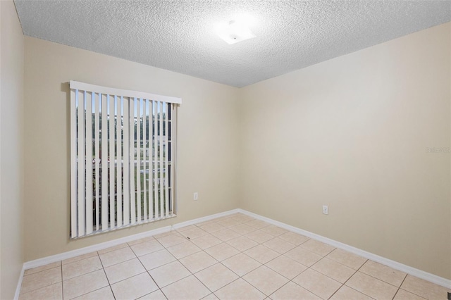 2304 Clementine Trl, Clermont, FL 34714 - empty room with a textured ceiling and light tile patterned flooring
