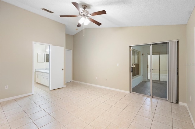 2304 Clementine Trl, Clermont, FL 34714 - empty room featuring vaulted ceiling, a ceiling fan, light tile patterned flooring, and a textured ceiling