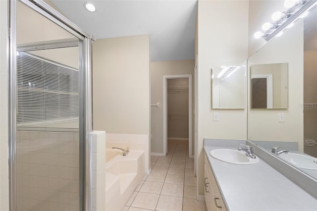 2304 Clementine Trl, Clermont, FL 34714 - full bathroom featuring tile patterned flooring, a garden tub, double vanity, a shower stall, and a walk in closet