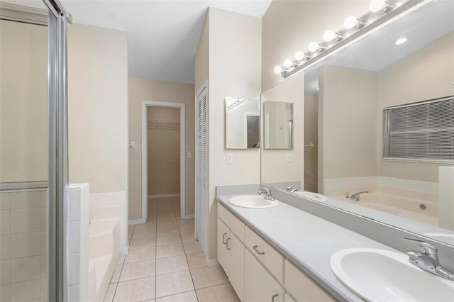2304 Clementine Trl, Clermont, FL 34714 - full bathroom featuring a garden tub, double vanity, tile patterned floors, a stall shower, and a spacious closet
