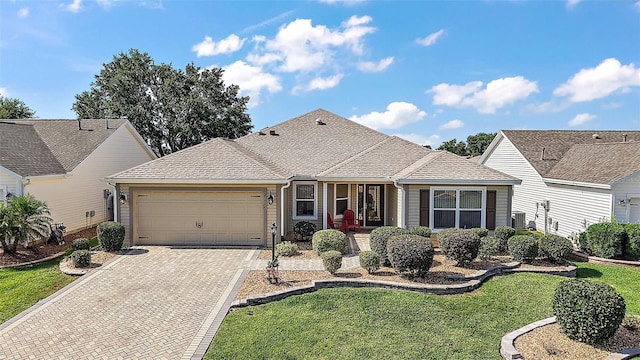 2096 Callaway Dr, The Villages, FL 32162 - view of front facade featuring a garage, driveway, a front lawn, and roof with shingles