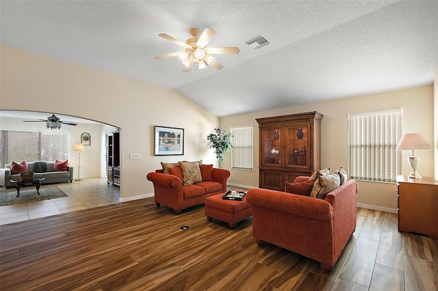 2096 Callaway Dr, The Villages, FL 32162 - living room featuring ceiling fan, lofted ceiling, arched walkways, baseboards, and wood finished floors