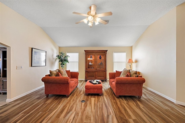 2096 Callaway Dr, The Villages, FL 32162 - living room with lofted ceiling, plenty of natural light, light wood-style flooring, a ceiling fan, and a textured ceiling