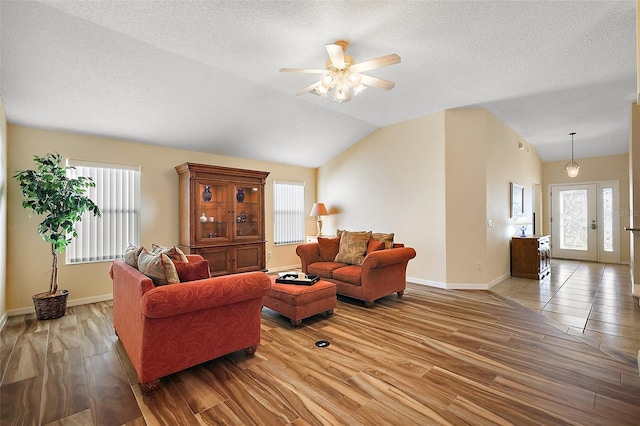 2096 Callaway Dr, The Villages, FL 32162 - living area featuring a ceiling fan, healthy amount of natural light, wood finished floors, baseboards, and a textured ceiling