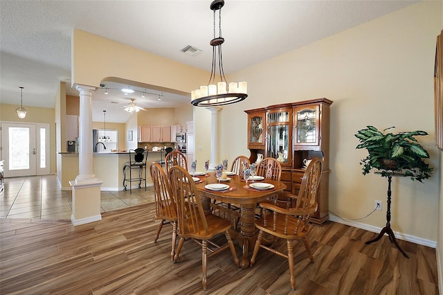 2096 Callaway Dr, The Villages, FL 32162 - dining room featuring ornate columns, ceiling fan, light wood-style floors, and baseboards