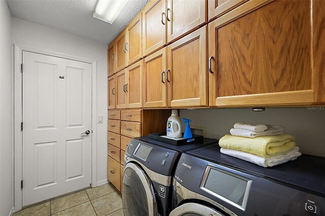 2096 Callaway Dr, The Villages, FL 32162 - washroom with cabinet space, independent washer and dryer, light tile patterned floors, and a textured ceiling