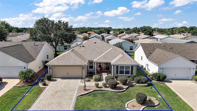 2096 Callaway Dr, The Villages, FL 32162 - view of front of property featuring driveway, a residential view, and an attached garage