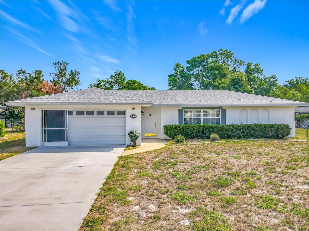 670 Oleander St, Mount Dora, FL 32757 - single story home with stucco siding, a garage, concrete driveway, and a shingled roof