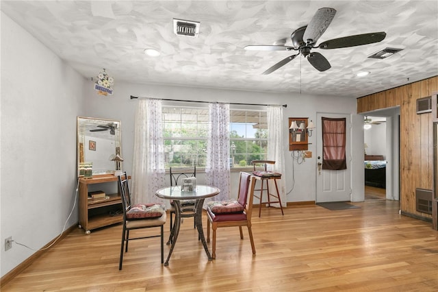 800 Jefferis Ct, Eustis, FL 32726 - dining space featuring a ceiling fan, light wood-type flooring, wood walls, and baseboards