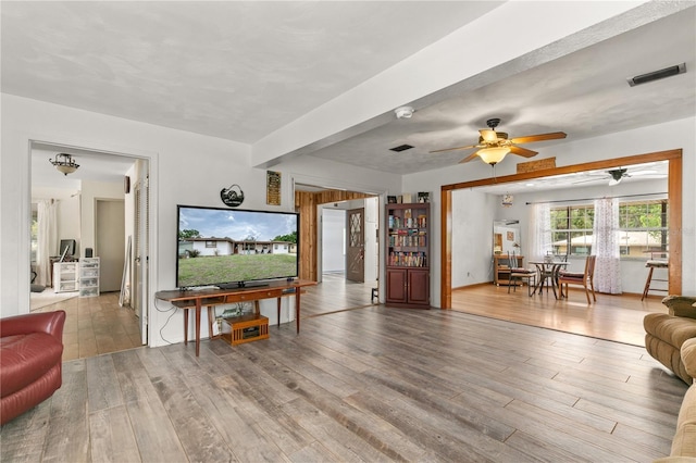800 Jefferis Ct, Eustis, FL 32726 - living room with a ceiling fan, wood finished floors, and beamed ceiling