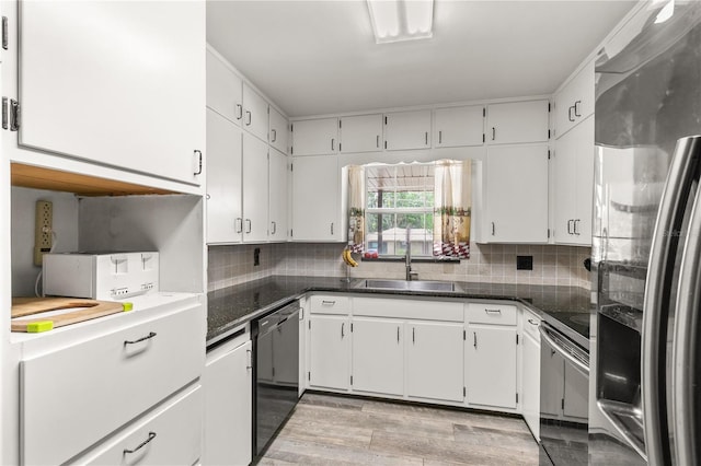 800 Jefferis Ct, Eustis, FL 32726 - kitchen with freestanding refrigerator, black dishwasher, range with electric stovetop, a sink, and white cabinets