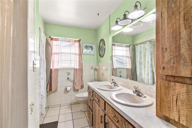 800 Jefferis Ct, Eustis, FL 32726 - bathroom featuring plenty of natural light, tile patterned floors, toilet, tile walls, and double vanity