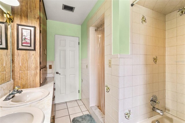 800 Jefferis Ct, Eustis, FL 32726 - bathroom with tile patterned flooring,  shower combination, double vanity, and tile walls