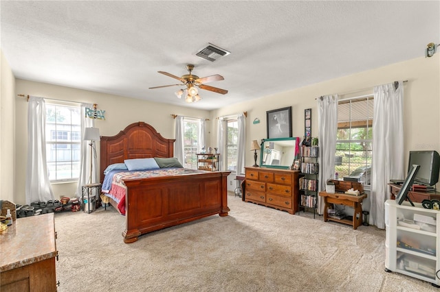 800 Jefferis Ct, Eustis, FL 32726 - bedroom with multiple windows, carpet floors, a textured ceiling, and a ceiling fan