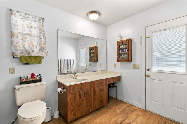 800 Jefferis Ct, Eustis, FL 32726 - bathroom with wood finished floors, vanity, baseboards, and toilet